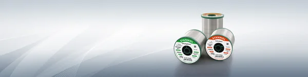 The picture shows three Stannol solder wire spools, two spools in a horizontal position and one upright. The two horizontal spools are Trilence 3505 and Kristall 611 solder wire.